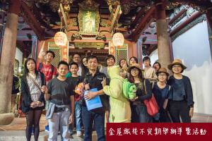 a group of people standing in front of a building at King Wow Inn in Tainan