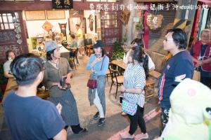 a group of people standing around in a restaurant at King Wow Inn in Tainan