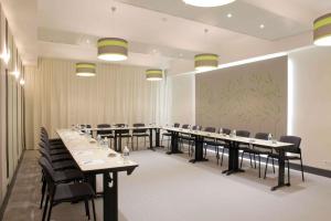 a conference room with tables and chairs and a large screen at Best Western Crequi Lyon Part Dieu in Lyon