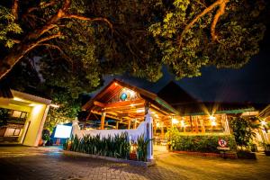 a building with a sign in front of it at night at Cakra Kusuma Hotel in Yogyakarta