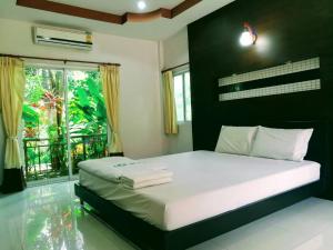 Postel nebo postele na pokoji v ubytování Pluluang Mansion