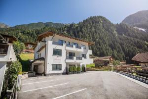 a large white building on the side of a road at Aurora Appartements in Neustift im Stubaital