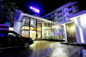 a car parked in front of a building at night at Galesia Hotel & Resort in Dhaka