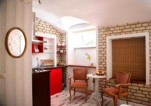 a kitchen with two chairs and a table in a room at Old Town cosy one bedroom apartments with fireplace in Vilnius