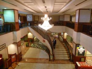 a man walking down a spiral staircase in a building at GOCOS Hotel in Klang