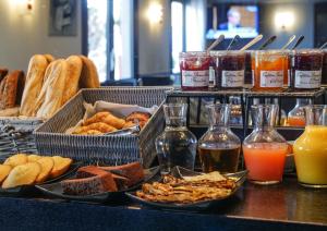 a buffet with different types of food and drinks at Hôtel Inn Design & Restaurant Rochefort in Rochefort