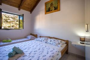 מיטה או מיטות בחדר ב-Holiday House Macić