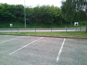 an empty parking lot on the side of a road at Hotel HECO Lyon sud Vienne in Vienne