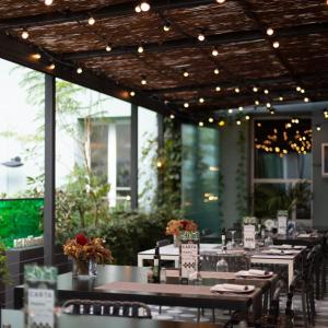 a dining room with tables and chairs and lights at Petit Palace Santa Bárbara in Madrid