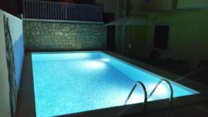 a large swimming pool in a dark room at Sunrise Apartments in Cavtat