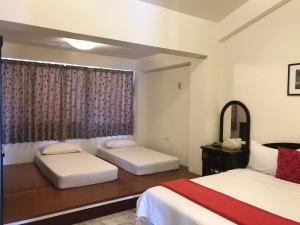 Postel nebo postele na pokoji v ubytování Kuo Kuang Hostel