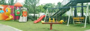 a park with a playground with slides and a slideintend at Lavenro Garden in Avissawella