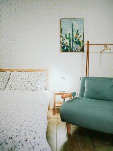 a bedroom with a bed and a couch at XiaoBei Home2 in Tainan