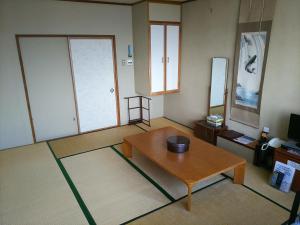 a living room with a coffee table and a television at Hakodate Park Hotel in Hakodate