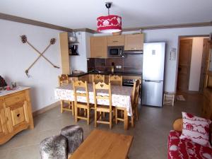 a kitchen and dining room with a table and chairs at les 7 laux immobilier chalet D in Prapoutel