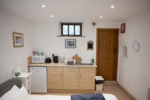 a small kitchen with a sink and a microwave at Anroach Farm Peak District in Buxton