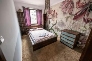 
Łóżko lub łóżka w pokoju w obiekcie Victus Apartamenty, Apartament Sensus
