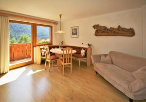 a living room with a couch and a table at Apartment Larjëi in Ortisei