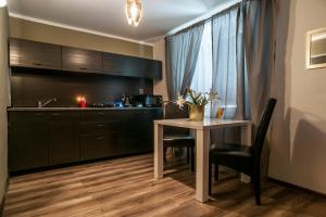 a kitchen with a table and a sink and a counter at STING Apartments Havířov in Havířov