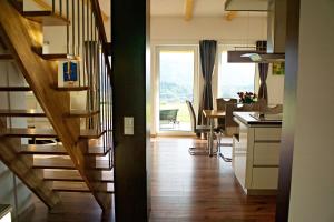 a room with a staircase and a kitchen with a table at Ferienhaus Kaiser in Gallizien