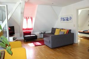 a living room with a couch and a tv at Haus Zur Gerberei 100 m zum Bodensee in Überlingen