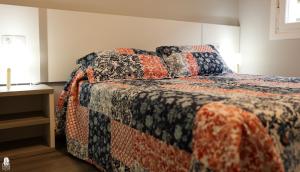 a bedroom with a bed with a quilt on it at dp85 Apartamentos in Sarria