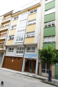 a building on the side of a street at dp85 Apartamentos in Sarria