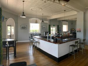 a bar with chairs and a counter in a room at Abermain Hotel in Abermain