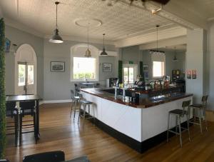 a bar with chairs and a counter in a room at Abermain Hotel in Abermain