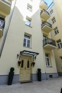 a building with a door and two balconies at Rental Apartments Wilcza in Warsaw