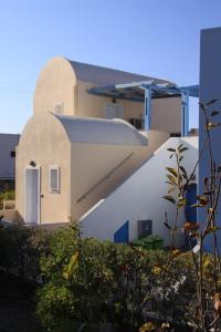 a large building with a large window at Maria's Place - Adults Only in Oia
