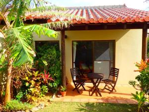 a patio of a house with two chairs and a table at Akachichi Guesthouse in Onna