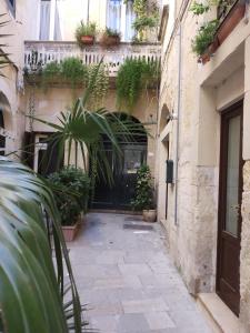 a building with a bunch of plants in front of it at Dimora "I Santi Patroni" in Lecce