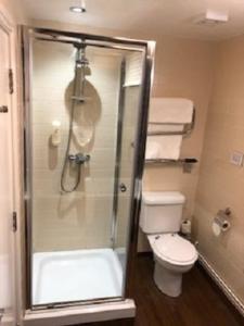 a bathroom with a shower and a toilet at Globe Hotel Wetherspoon in King's Lynn
