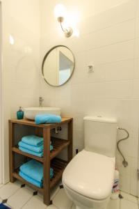 a bathroom with a white toilet and a sink at Rental Apartments Wilcza in Warsaw