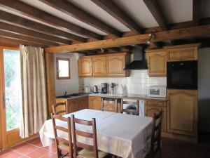 a kitchen with a table and chairs and a table and a kitchen at Appartement au bord de l'Eure in Léry
