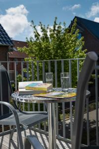 a table with a book and two glasses on it at Scharhörn-Riff - 16 in Cuxhaven