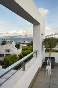 a balcony with a view of the ocean at the coolest loft and terrace-varkiza sea view in Varkiza