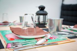 a table with a plate and utensils on a table at Di Palma Suite in Naples +53 photos