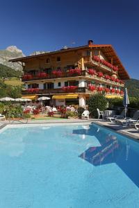 a large swimming pool in front of a hotel at Le Chamois d'Or in Cordon