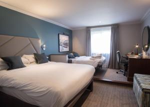 Katil atau katil-katil dalam bilik di Cottons Hotel and Spa