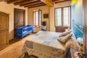 a bedroom with a large bed and a blue dresser at Casa La Escuela in Tuilla