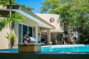 a house with a swimming pool in front of a house at 3BR Home, Steps from Spectacular Beach, Private Pool in Playa del Carmen