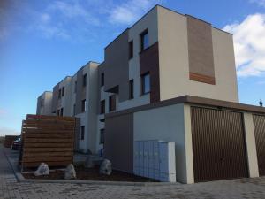 a large white building with a dog sitting on top of it at Apartament Fibra Cappuccino in Rybnik