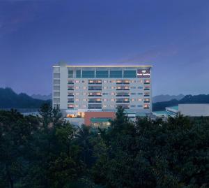 a large building with lights on in front of it at Hotel Santika Bogor in Bogor