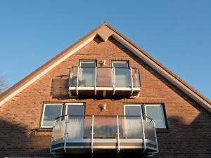 a building with two balconies on the side of it at Appartement Strandstraße 10, Büsum in Büsum