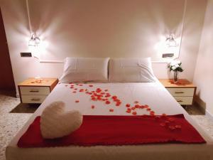 a bedroom with a bed with red flowers on it at Casa Nives in Villa Emilia in Vietri sul Mare