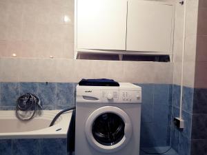 a washing machine in a bathroom next to a tub at Casa Nives in Villa Emilia in Vietri