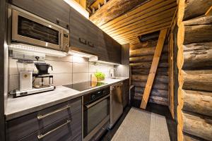 a kitchen with a sink and a stove top oven at UnelmaKaukelo in Ruka