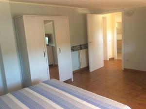 a bedroom with a bed and a hallway with doors at Casa Tacconi in Villasimius